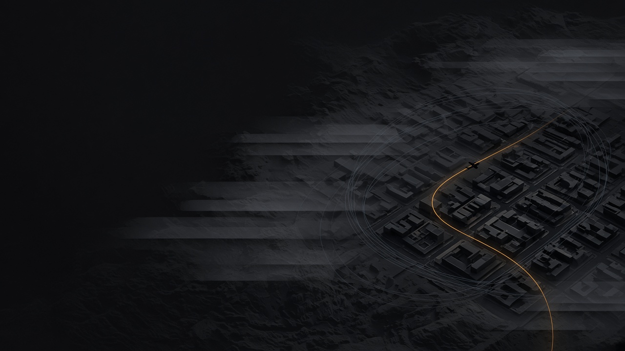 An illustration of a city from above, its buildings in grey, with one amber route curving through the streets.